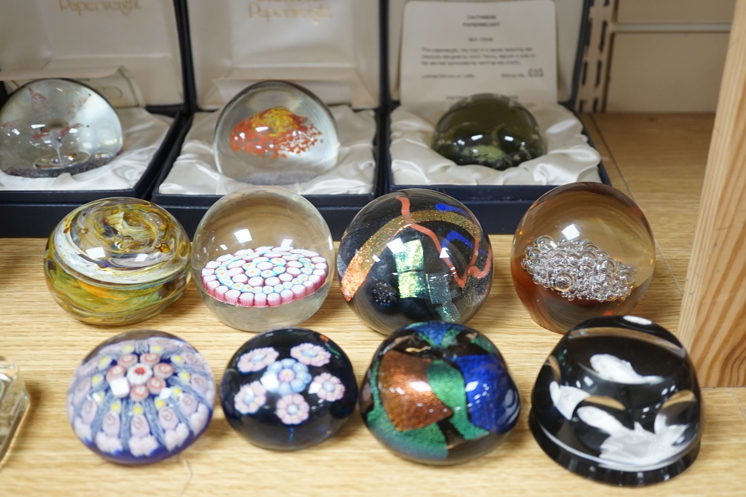 2 Caithness glass vases together with 11 various paperweights, including 3 boxed Caithness and a Baccarat paperweight.
